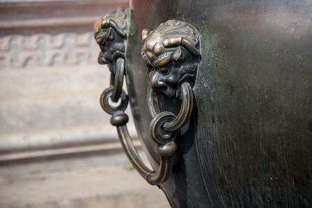 Details of an ancient water vat with lions headの写真素材