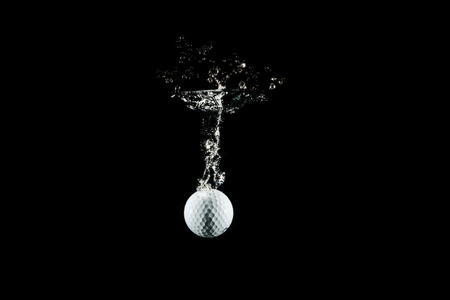 golf ball plunge in the waterの写真素材