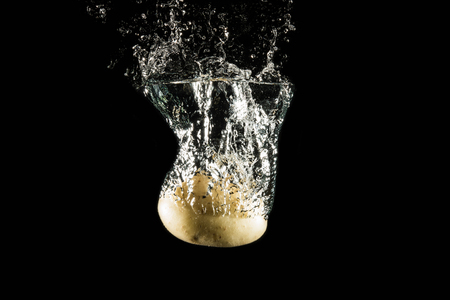 Potatoes falling into the waterの写真素材