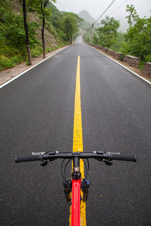 The rugged mountain road is shrouded in haze in Beijing, Chinaの写真素材