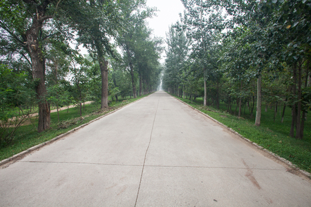 The rugged mountain road is shrouded in haze in Beijing, Chinaの写真素材