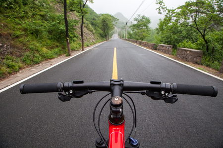 The rugged mountain road is shrouded in haze in Beijing, Chinaの写真素材