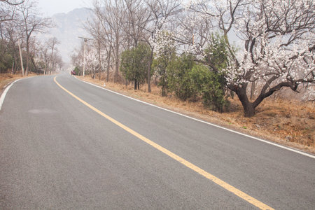 The rugged mountain road is shrouded in haze in Beijing, China