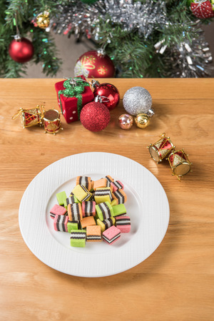 The sugar in the white bowl is on the wooden table and Christmas decorations.の写真素材
