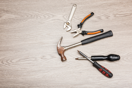 The repair tools is placed on the wooden table.の写真素材