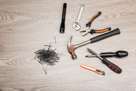 The repair tools is placed on the wooden table.の写真素材