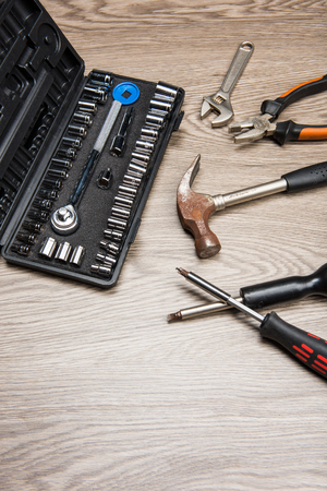 The repair tools is placed on the wooden table.の写真素材