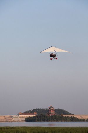 paramotor flying on blue skyの写真素材