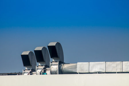 Industrial air conditioning and ventilation systems on a roof,on blue isolated.