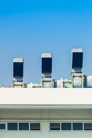 Industrial air conditioning and ventilation systems on a roof,on blue isolated.の写真素材