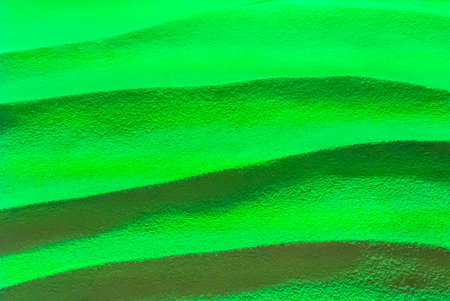 Green lighting on wave cement background の写真素材