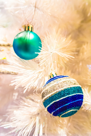 Close-up of Christmas ornaments on White Christmas tree Background.の写真素材