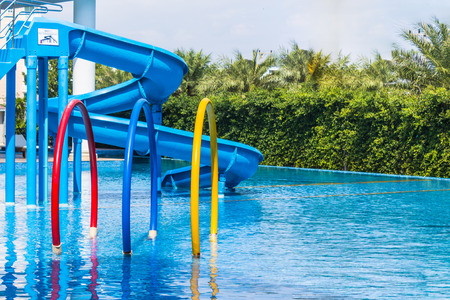 Colorful waterpark tubes and pool in tropical aquapark.のeditorial素材