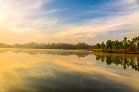 Lake in the morning light and fog reflection.