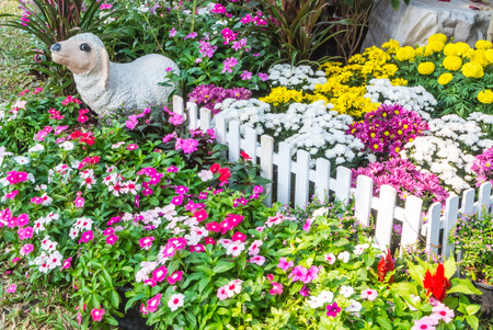 Sheep statue in flower garden.の写真素材