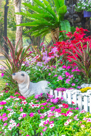 Sheep statue in flower garden.の写真素材