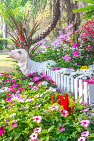 Sheep statue in flower garden.の写真素材