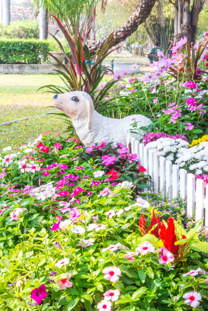 Sheep statue in flower garden.の写真素材