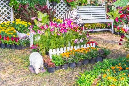 Sheep statue in flower garden.の写真素材