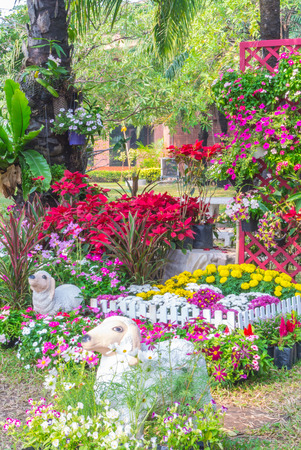 Sheep statue in flower garden.の写真素材