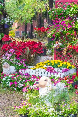 Sheep statue in flower garden.の写真素材