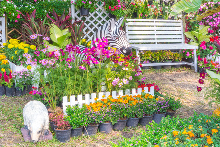 Sheep statue in flower garden.の写真素材