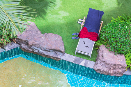 Top view of a garden with armchairs on the lawn and pool.の写真素材