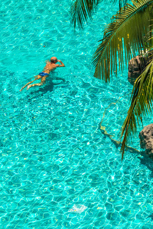 Man swimming in the crystal-clear pool.の写真素材