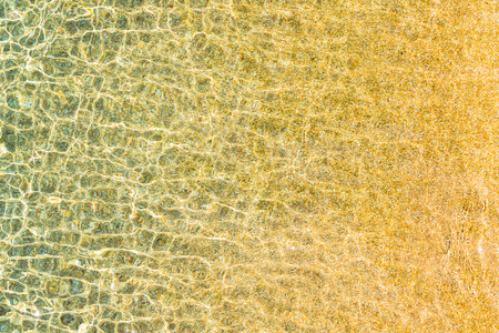 Swimming pool water surface with sparkling light reflection.の写真素材