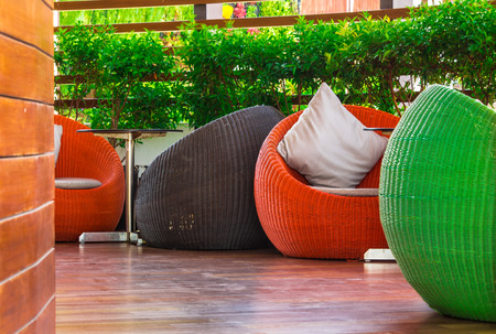 Multi color round wicker Table sets in garden.の写真素材
