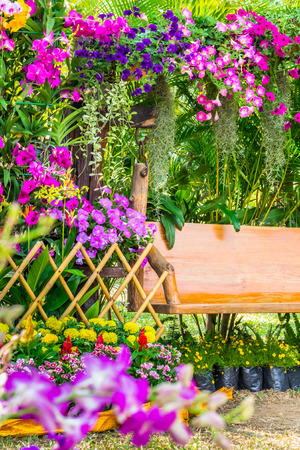 Picket fence surrounded by flowers in a front yard on summer.の写真素材