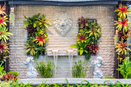 Concept and idea waterfall with Statue Cupid and lion in cozy garden.の写真素材