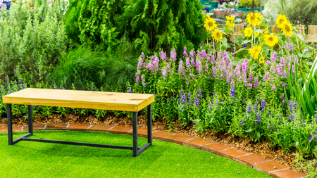 Wood couch in flower cozy garden on summer.の写真素材