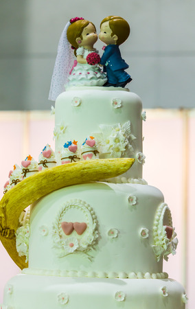 Sweet beauty flower and topping wedding couple doll on wedding cake decoration.の写真素材