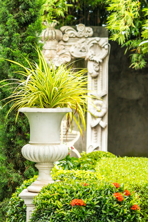 Gothic flower pot in cozy garden on summer.の写真素材