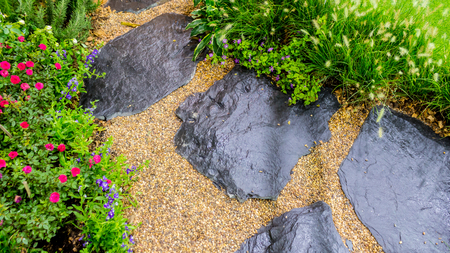 Stone walkway in cozy garden with flower and plant.の写真素材