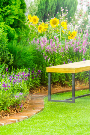 Wood couch in flower cozy garden.の写真素材
