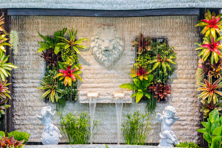 Concept and idea waterfall with Statue Cupid and lion in cozy garden.の写真素材