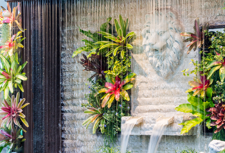 Concept and idea waterfall with Statue Cupid and lion in cozy garden.の写真素材