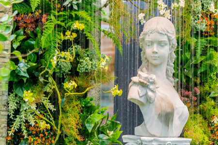 Statue angel and waterfall in cozy garden.のeditorial素材