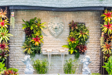 Concept and idea waterfall with Statue Cupid and lion in cozy garden.の写真素材
