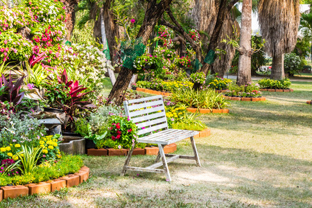 White chair in cozy flower garden on summer.の写真素材