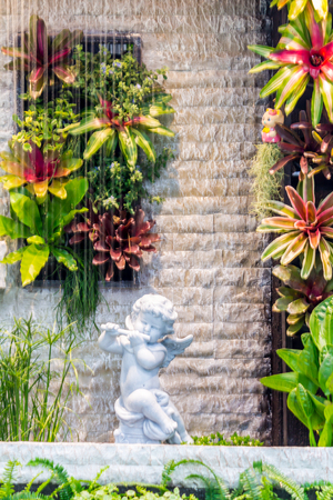 Statue Cupid and waterfall in cozy garden.の写真素材
