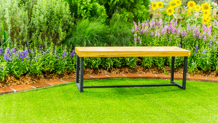 Wood couch in flower cozy garden.の写真素材