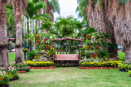 Wood chair in cozy flower garden and flower pot decoration on summer.の写真素材