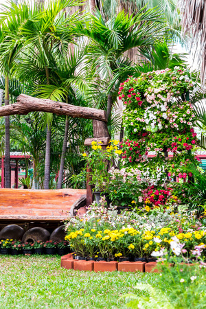 Wood chair in cozy flower garden and flower pot decoration on summer.の写真素材