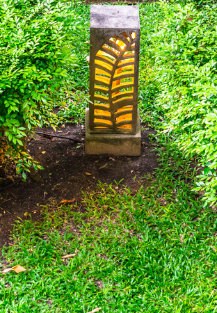 Carved stone lamp decoration in cozy home garden on summer.の写真素材