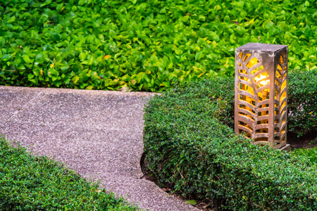 Carved stone lamp decoration in cozy home garden on summer.の写真素材