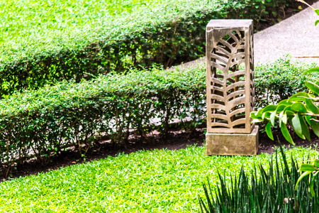 Carved stone lamp decoration in cozy home garden on summer.の写真素材