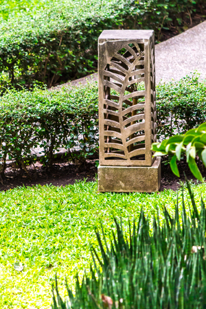 Carved stone lamp decoration in cozy home garden on summer.の写真素材